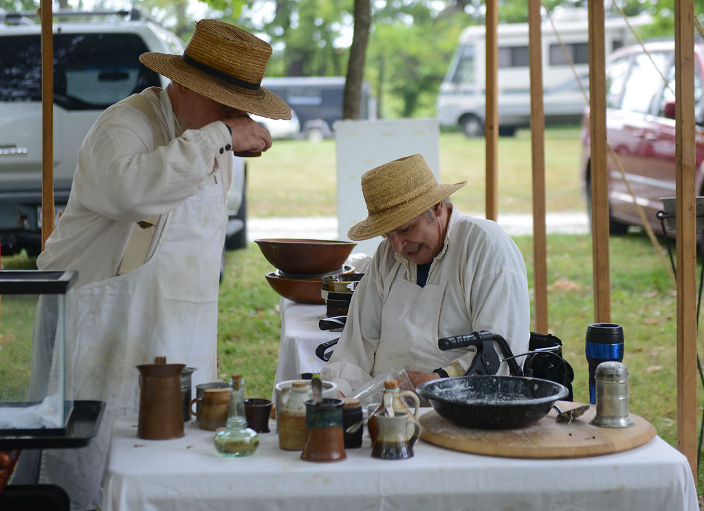 Scott Stager and Gordon Springer talk as Springer prepares a jar for bread dough